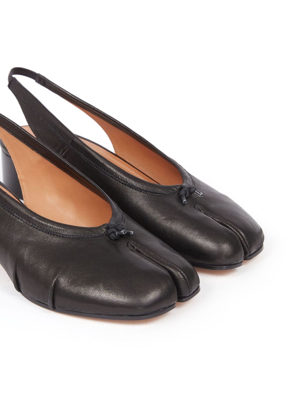 Pair of black leather tabi shoes on a white background