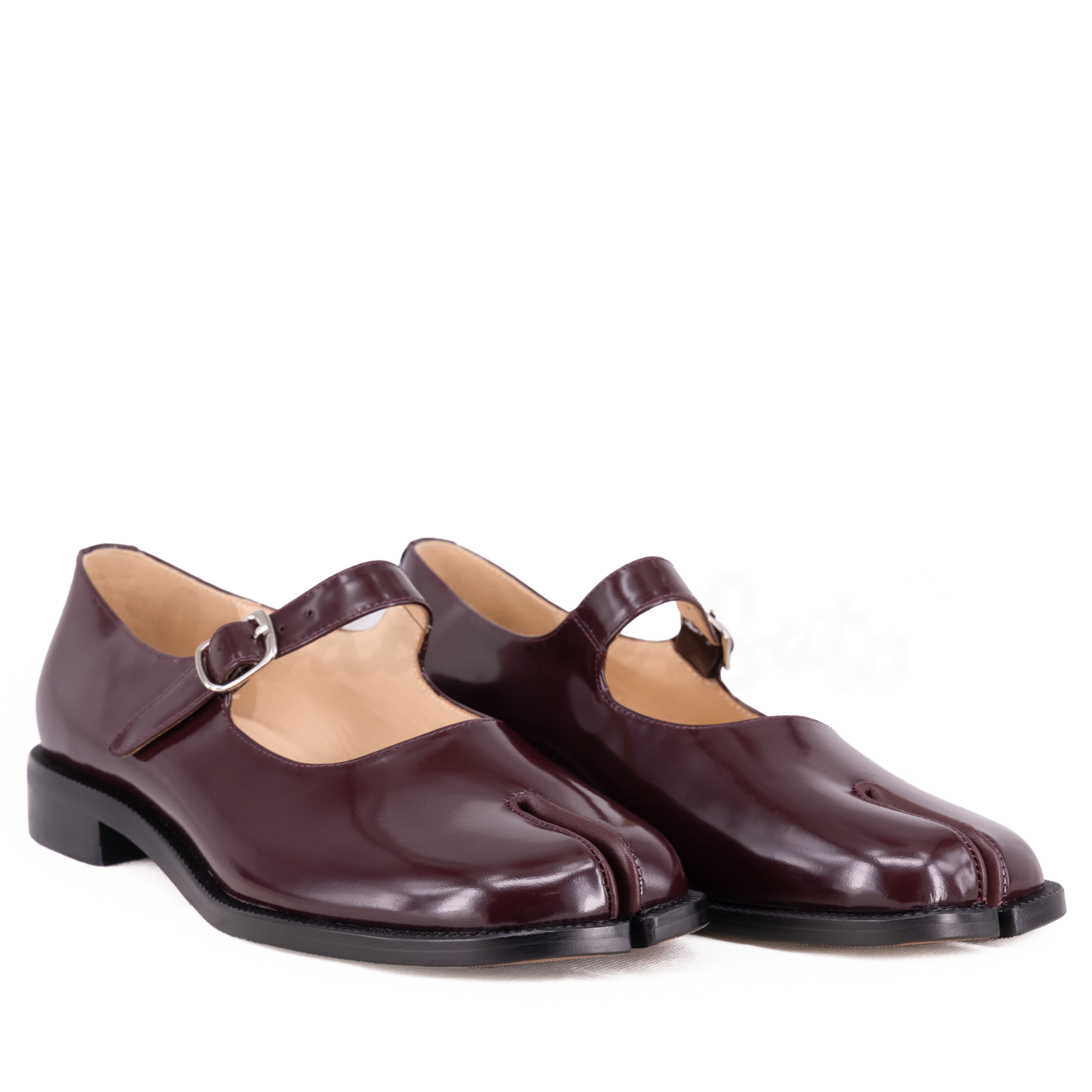 Pair of brown shoes with a strap on a white background