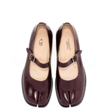 Pair of brown shoes with a strap on a white background