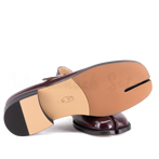 Close-up of a shoe sole with a visible brand logo on a white background