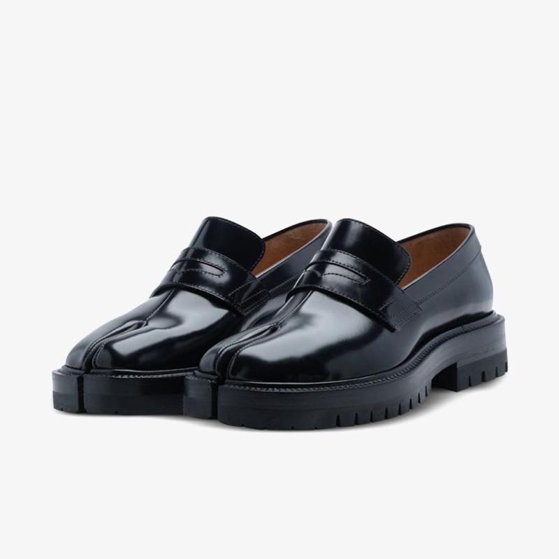 Pair of black loafers on a light gray background